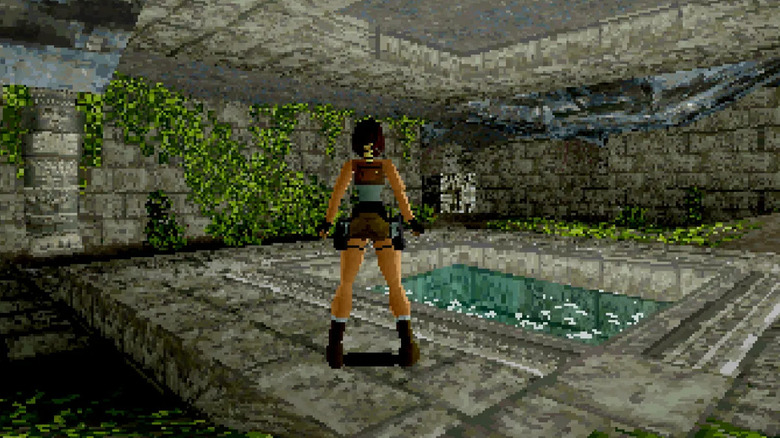 Lara Croft stands near a pool of water in Tomb Raider (1996)