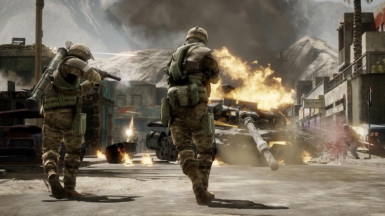 Two soldiers running and firing weapons at a tank in Battlefield Bad Company 2