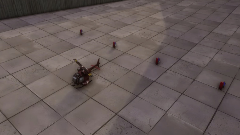 A remote-controlled helicopter rests on the ground alongside four bombs in Grand Theft Auto Vice City