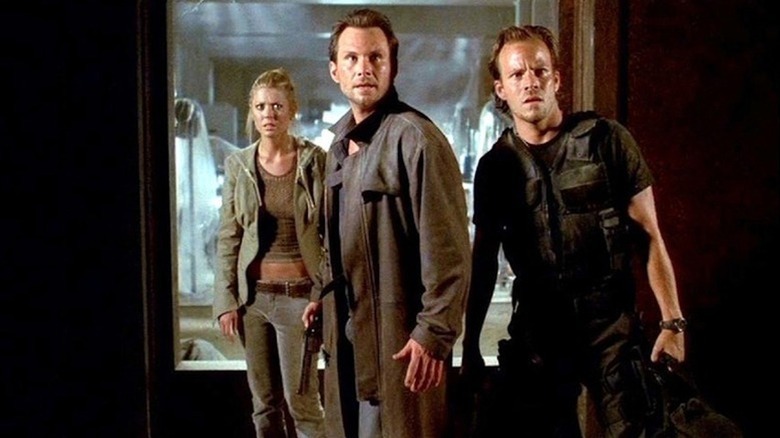 Aline Cedrac, Edward Carnby, and Richard Burke stand shocked in a doorway in "Alone in the Dark" (2005)