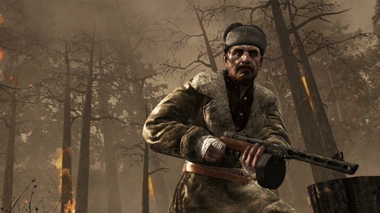 A Soviet soldier holds a submachine gun in a burning forest in Call of Duty: World at War