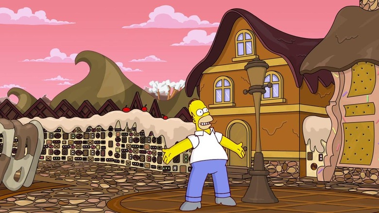 Homer Simpson stands triumphantly in a town made of chocolate in The Simpsons Game