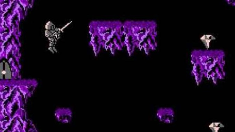 A knight leaps towards a platform in Wizards & Warriors
