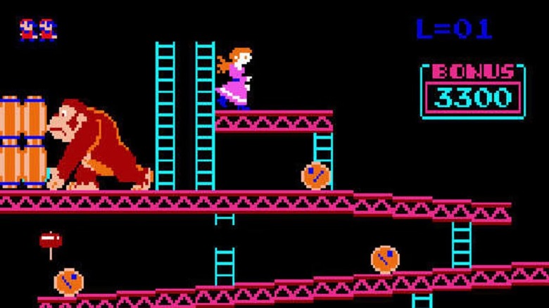 Donkey Kong rolls barrels while Pauline stands on a platform in Donkey Kong