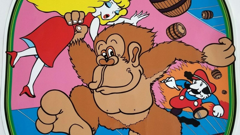 Donkey Kong carries Pauline while being pursued by Mario on the arcade cabinet artwork for Donkey Kong