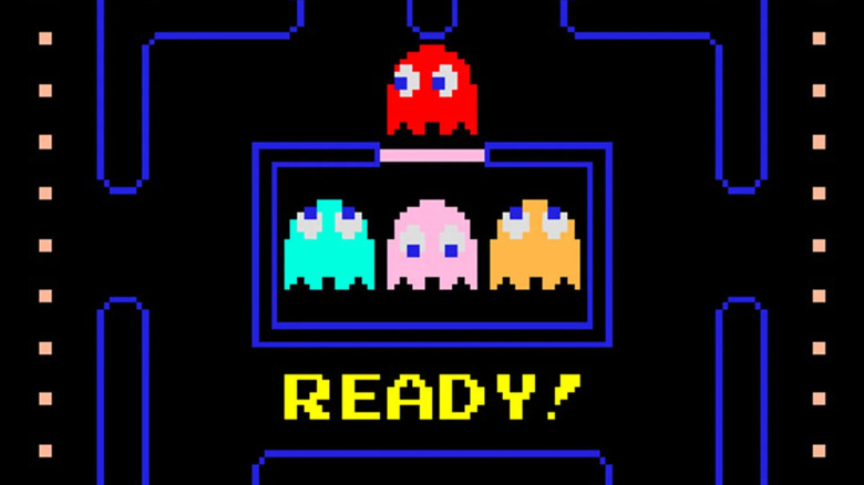 A red ghost emerges from a cell in Pac-Man