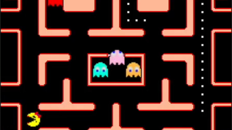 Ms. Pac-Man is in the bottom left corner of the screen as three ghosts sit in their holding cell in "Ms. Pac-Man" (1982)