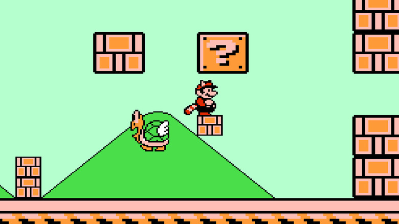 A Tanooki-suited Mario stand under an enlarged question mark block by a large parakoopa in "Super Mario Bros. 3" (1988)