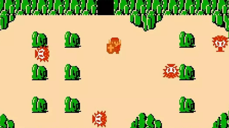 Link is surrounded by Octoroks and boulders in "The Legend of Zelda" (1986)