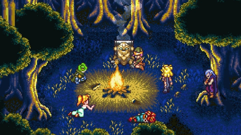 Crono and his friends gather around a campfire in a forest in "Chrono Trigger" (1995)