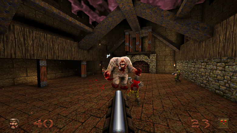 The player advances on soldiers fighting a monster in Quake