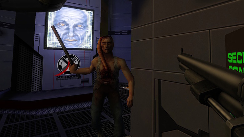 The player, armed with a shotgun, advances on a mutant in System Shock