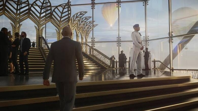 Agent 47 walks through a gala in Hitman 3