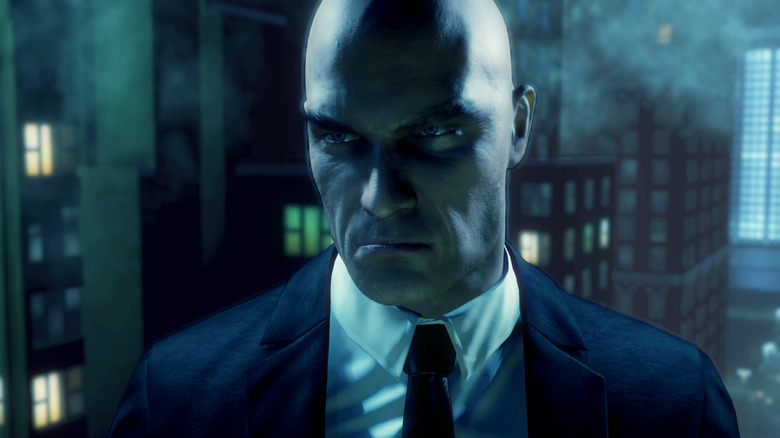 Agent 47 glares from a rooftop in Hitman: Absolution