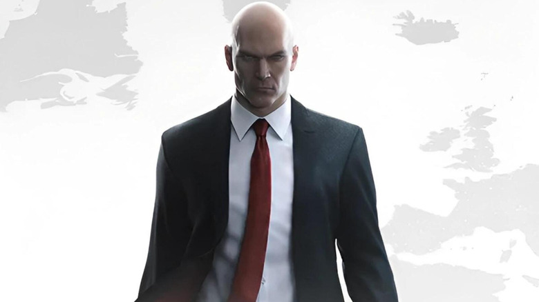 Agent 47 stands in front of a white map on the cover art for Hitman