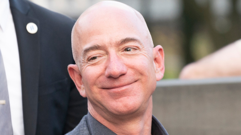 Jeff Bezos walking with guards