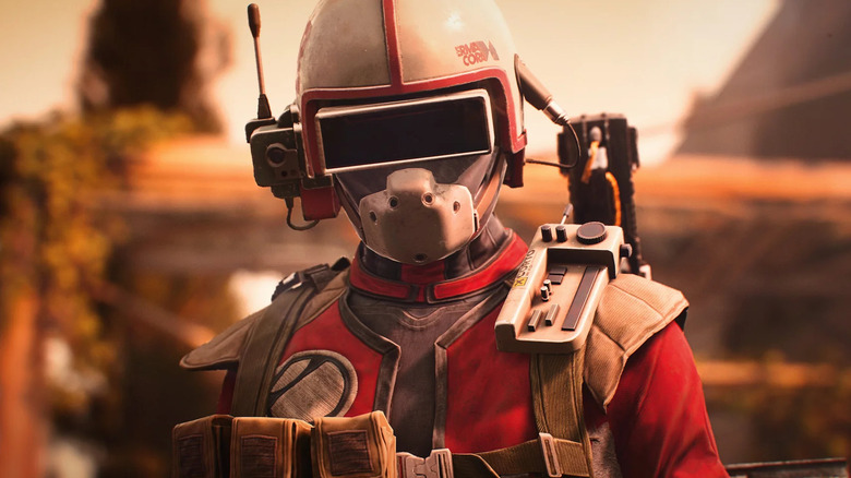 A helmeted raider in red stands in ARC Raiders