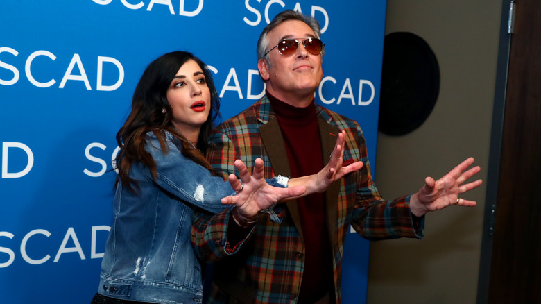 Dana DeLorenzo and Bruce Campbell posing