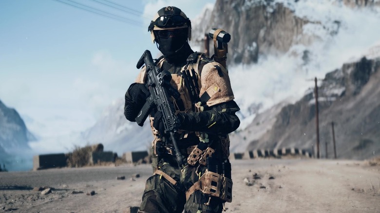 A soldier holds an assault rifle while walking through a mountain pass in Battlefield 6