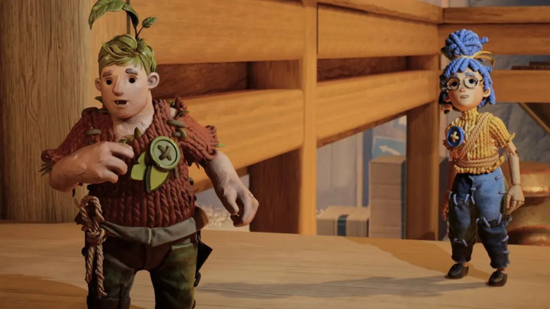 Cody and May speak on a wooden table as handmade dolls in "It Takes Two" (2021)