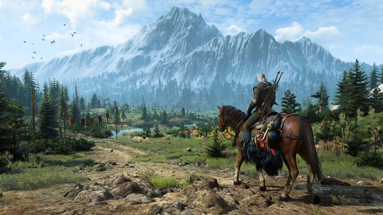 Geralt of Rivia rides his horse across mountainous countryside in The Witcher 3: Wild Hunt