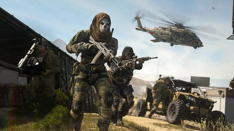 Soldiers moving forward with chopper overhead