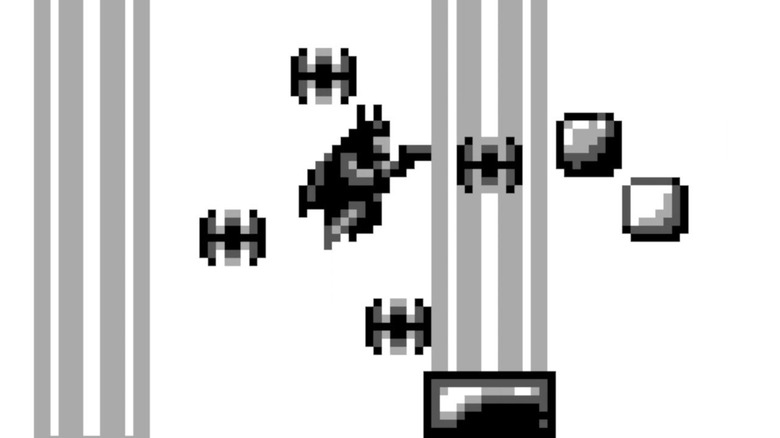 Batman jumps surrounded by Batarangs in Batman: The Video Game