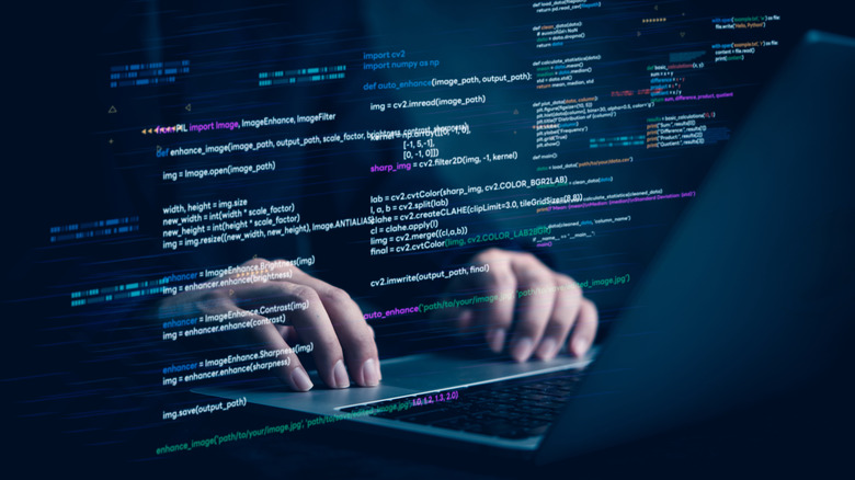 Two hands at a keyboards with an overlay of computer programming commands