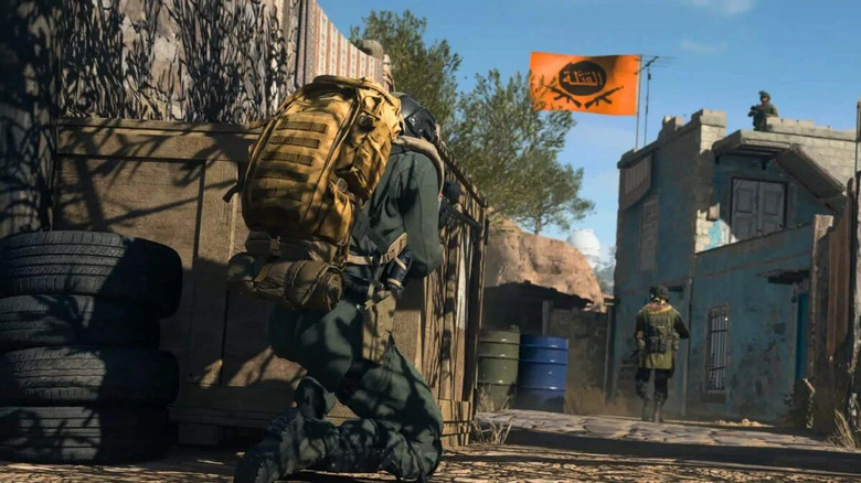 Warzone 2.0 player kneeling behind dumpster