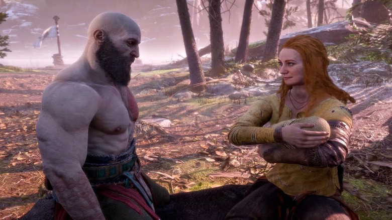 Kratos sitting with Faye and Atreus as a baby