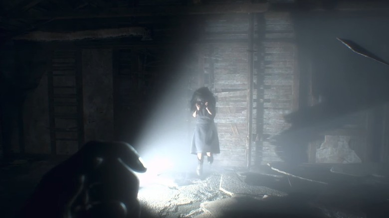 Ethan faces Eveline in the attic of the Bakers' home.