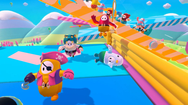 Fall Guys in various costumes racing