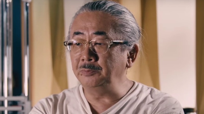 Nobuo Uematsu sitting at piano