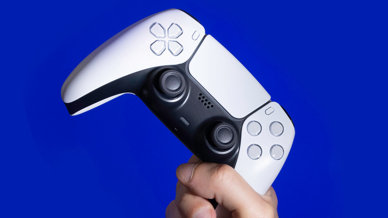 Hand Holding PS5 Controller