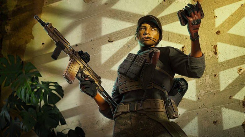 operator holding a gun and an electronic device