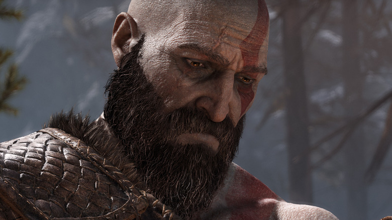 Kratos looks pensively down at bag