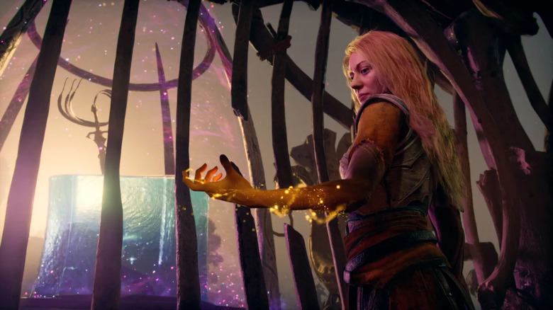 Faye channels power through her hand while trying to free Phranque in God of War Laufey
