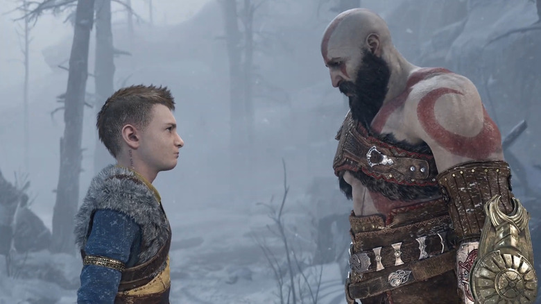 Atreus and Kratos look at each other deeply in a snowy forest in God of War: Ragnarök
