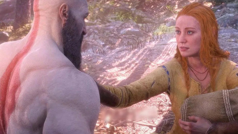 Faye puts a hand on Kratos' chest while holding a baby in God of War: Ragnarök