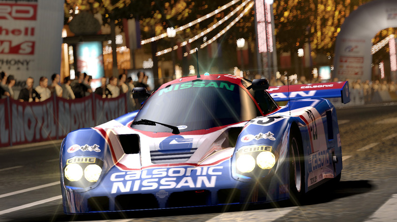red, white and blue race car on track