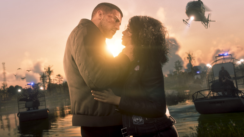 Jason Duval and Lucia Caminos embrace while surrounded by law enforcement in Grand Theft Auto 6