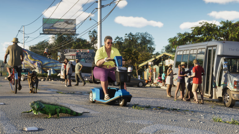 A person rides a mobility scooter as a lizard crosses the road in the Leonida Keys area of Vice City in Grand Theft Auto 6