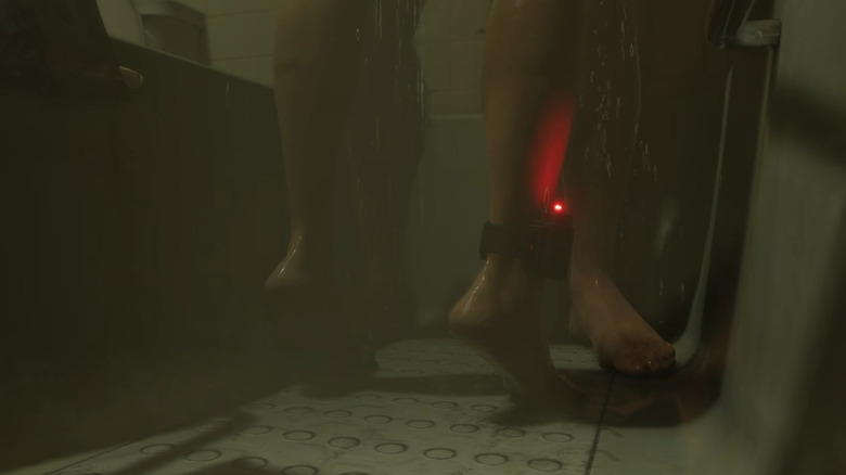 Jason and Lucia's feet in the shower showing an ankle monitor