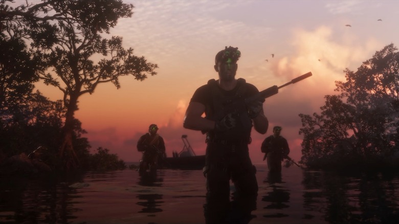 Jason and two other men in military gear crossing a swamp
