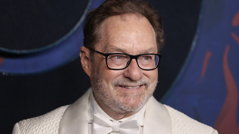 Actor Stephen Root in a white suit smiling
