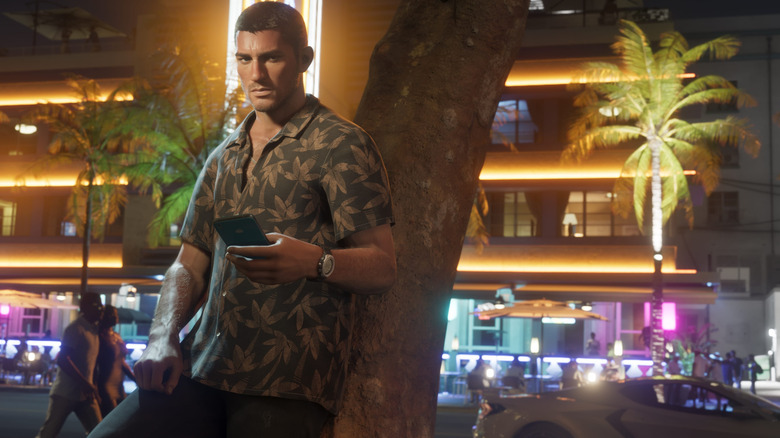 Jason leaning against a tree while holding a phone in GTA 6
