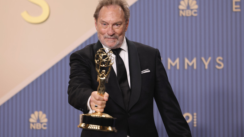 Stephen Root holding an Emmy award