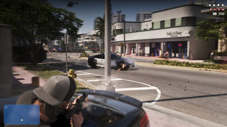 Jason Duval fires a rifle at a cop car from a movng vehicle in Grand Theft Auto 6