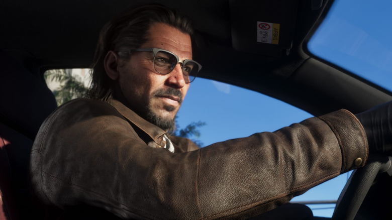 Raul Batista sits behind the wheel of a car wearing sunglasses in Grand Theft Auto 6