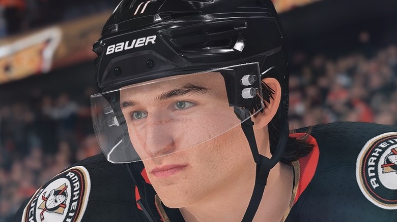 A screenshot from NHL 23, showing a closeup of a player's face. He's wearing a black helmet with a clear visor.